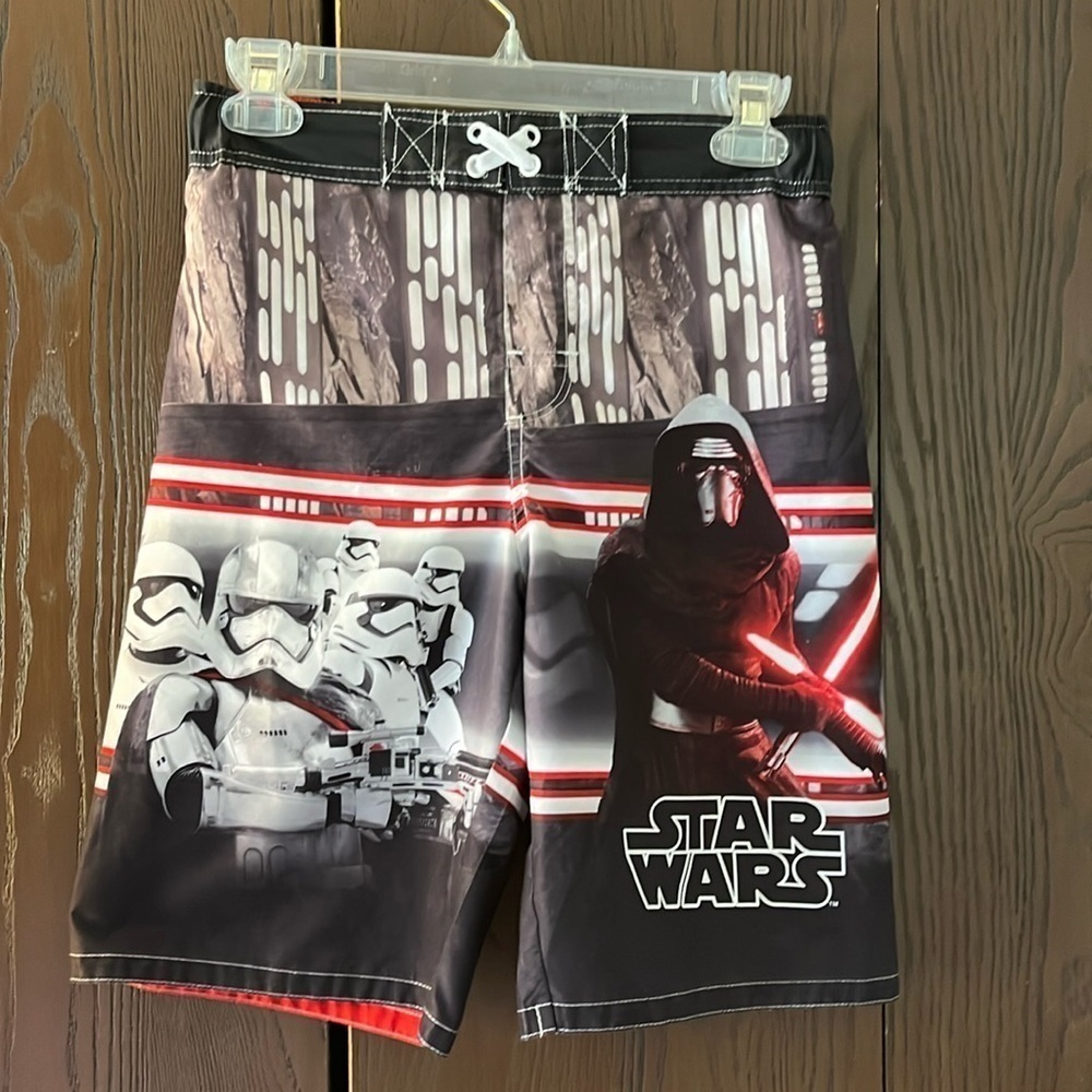 Star Wars boy’s black swim trunks with Star Wars characters. Size Large.